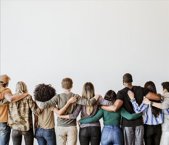 Our Community - image of group of people with arms around each other